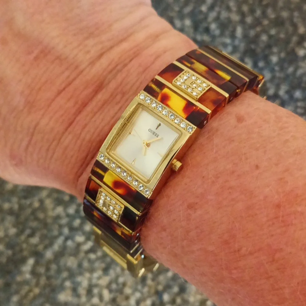 Guess gold tone crystal and tortoise shell womens iconic bracelet watch
